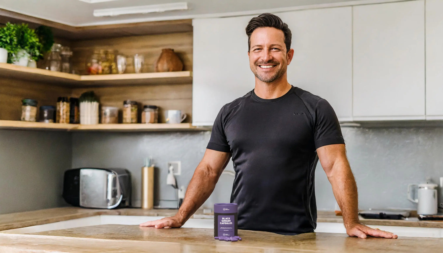 Man in kitchen with Black Ginger Capsules